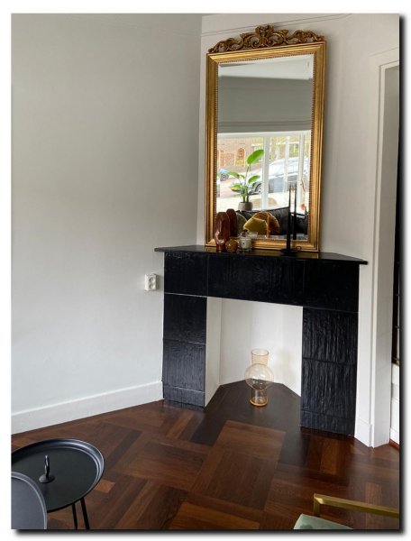 gouden-spiegel-met-kuif-boven-zwarte-schouw-in-jar